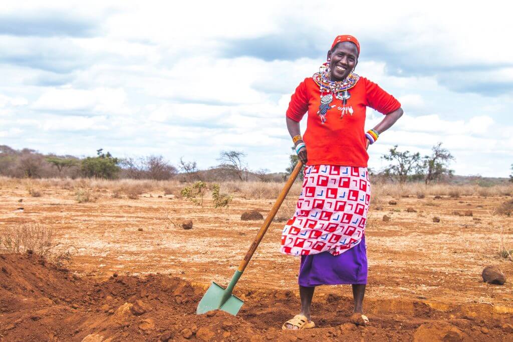 Woman shovel digging bund